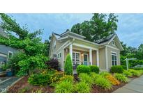 Charming craftsman home with manicured landscaping and inviting front porch featuring a painted blue door at 729 Lorentello Cir, Hillsborough, NC 27278