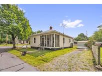 Charming single-Gathering home with a screened porch, well-maintained lawn, and gravel driveway at 804 Delaware Ave, Burlington, NC 27217