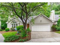 Charming home with a two-car garage, lush green lawn, mature trees, and well maintained landscaping at 100 Culbreth Rd # C, Chapel Hill, NC 27516