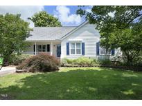 Charming home features a well-manicured lawn and beautiful landscaping at 109 Perry Farms Dr, Apex, NC 27502
