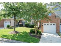 Charming brick townhome with well-manicured lawn and mature trees providing shade and curb appeal at 11217 Maplecroft Ct, Raleigh, NC 27617
