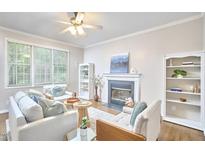 Cozy living room with a fireplace, comfortable seating, and natural light creates an inviting atmosphere at 142 College Ave Ave, Durham, NC 27713