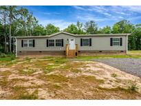 Charming single-story home with gray siding, black shutters, and a welcoming front porch at 150 Will Woods Way, Franklinton, NC 27525