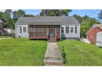 Charming single-story home with a screened-in porch and well-maintained front yard at 1818 Cecil St, Durham, NC 27707