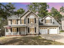 Charming two-story home featuring a covered front porch and a two-car garage at 216 Captain Harbor Hbr, Sanford, NC 27332