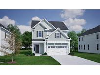 Charming two-story home with gray siding, black shutters, and a two-car garage at 267 Meadowbark Bnd # 34, Garner, NC 27529