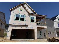 Two story home features covered porch and windows ready for exterior finishes at 268 Meadowbark Bnd # 42, Garner, NC 27529