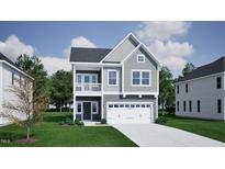 Charming two-story home with a balcony, attached garage, and a well-manicured lawn at 268 Meadowbark Bnd # 42, Garner, NC 27529