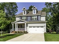 Charming two-story home with a well-manicured lawn and attached two-car garage at 301 Sawgrass Ct, Mebane, NC 27302
