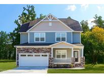 Charming two-story home featuring stone accents, a covered porch, and an attached two-car garage at 301 Sawgrass Ct, Mebane, NC 27302