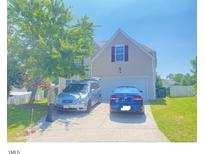 Charming home features a well-maintained lawn, two-car garage and mature tree providing shade at 3207 Geary Trl, Raleigh, NC 27610