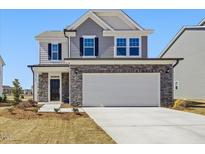 Charming two-story home with stone accents and a spacious two-car garage at 425 Hipwood Dr, Zebulon, NC 27597