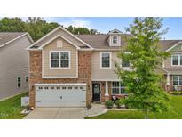 Charming two-story home featuring a brick and siding facade, attached garage and manicured landscaping at 542 Spaulding St, Burlington, NC 27215