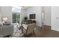 Bright living room with modern decor, hardwood floors, and large sliding doors to a balcony at 600 S Duke St # 24, Durham, NC 27701