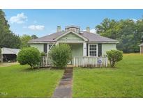 Charming one-story home with a quaint front porch and green lawn at 620 Mcadams Rd, Hillsborough, NC 27278