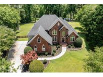 Beautiful brick two-story home featuring mature landscaping, a well-manicured lawn, and a classic architectural design at 6553 Vintage Ridge Ln, Fuquay Varina, NC 27526