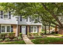 Charming brick townhome with manicured landscaping and a welcoming front entrance at 7731 Kingsberry Ct, Raleigh, NC 27615
