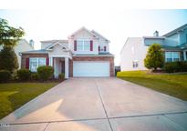 Charming two-story home with manicured lawn and a two car garage at 8021 Wesley Farm Dr, Raleigh, NC 27616