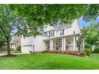 Charming two-story home featuring a welcoming front porch and well-manicured lawn and two-car garage at 106 Roundtop Rd, Cary, NC 27519