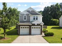 Charming two-story home with a well-manicured lawn, a two-car garage, and lovely landscaping at 109 Citrine Ct, Durham, NC 27703