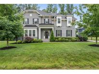 Beautiful two-story gray home with lush green lawn and manicured landscaping at 1324 Sandybrook Ln, Wake Forest, NC 27587