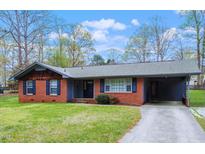 Charming brick home featuring a carport and well-maintained front yard, perfect for comfortable suburban living at 1813 Grady Dr., Durham, NC 27712