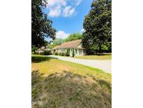 Charming single-Gathering home with a long drive surrounded by lush greenery at 304 Sandalwood Ave, Louisburg, NC 27549