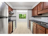 Traditional kitchen with stainless steel appliances and wood cabinets at 3088 Colony Rd # A, Durham, NC 27705