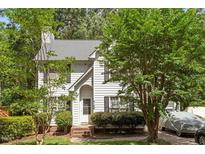 Charming two-story home with white siding, mature trees, manicured landscaping, and an inviting front entrance at 4108 Lazyriver Ln, Durham, NC 27712