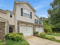 Charming townhome featuring a two-car garage and a mix of siding and stone facade at 4719 Altha St, Raleigh, NC 27606