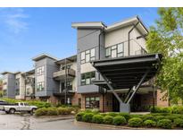 Modern building with neutral tones, balconies and lush landscaping for a contemporary feel at 515 N Churton St # 203, Hillsborough, NC 27278