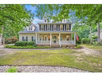 Charming two-story home featuring a welcoming front porch and well-maintained landscaping at 618 Durwood Dr, Raleigh, NC 27603