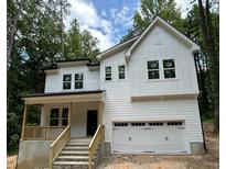 New two story home with an attached two car garage and a cozy front porch and stone steps at 701 Locust Ln, Raleigh, NC 27603