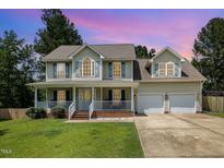 Charming two-story home with a welcoming front porch and well-manicured lawn at 105 Rolling Stone Ct, Sanford, NC 27332