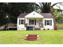 Charming single-story home with covered front porch and a well-maintained lawn and brick steps at 1611 Robinhood Rd, Durham, NC 27701