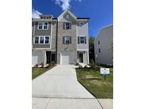 Attractive townhome with brick and siding facade, featuring a one-car garage and well-maintained lawn at 1916 Fishamble St # 22, Fuquay Varina, NC 27526