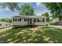 Charming single-story home with a well-manicured lawn, wood stairs, and a traditional design at 2112 Mckinney St, Burlington, NC 27217