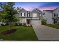 Charming two-story home with gray siding, stone accents, manicured lawn, and an inviting two-car garage at 4508 Valley Crest Ln, Fuquay Varina, NC 27526
