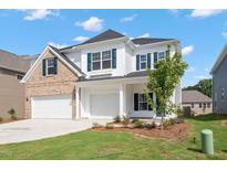 Charming two-story home with white siding, brick accents, a three-car garage, and a well-manicured lawn at 84 Black Walnut Dr # 200, Garner, NC 27529