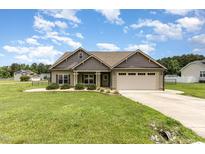 Charming single-Gathering home with well-manicured lawn, two-car garage, and inviting curb appeal at 235 Camden Place St, Princeton, NC 27569