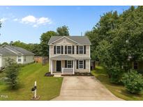 Charming two-story home featuring a well-maintained lawn and a classic design at 5012 Silverdene St, Raleigh, NC 27616