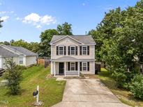 Charming two-story home with a welcoming porch and well-maintained lawn at 5012 Silverdene St, Raleigh, NC 27616