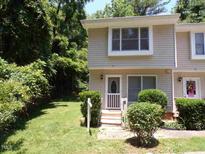 Inviting townhouse featuring manicured landscaping and a charming entryway with a well-lit front porch at 875 Mlk Jr Boulevard,15, Chapel Hill, NC 27516