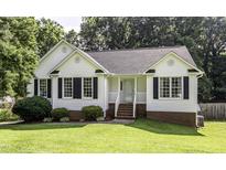 Charming home featuring a well-manicured lawn and complemented by black shutters at 1112 Newberry Dr, Mebane, NC 27302