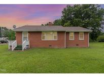 Cozy brick home featuring well-kept lawn and secure ADT protection at 1209 Bobbitt Dr, Garner, NC 27529