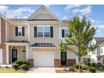 Charming townhome featuring an attached garage, a well maintained lawn and delightful front yard landscaping at 1217 Trilogy Blvd # 174, Morrisville, NC 27560