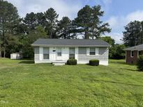 Charming single story home with manicured lawn and mature trees at 124 Kearney Ave, Oxford, NC 27565
