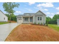 Charming single-Gathering home with covered porch, attached garage, and newly seeded front yard at 147 Harmony Trl, Broadway, NC 27505
