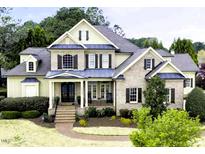 Charming two-story brick home with a manicured front yard and inviting covered front porch at 1512 Obrien Cir, Wake Forest, NC 27587