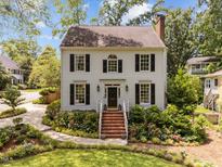 Charming two-story home with a landscaped front yard and brick stairs leading to the front door at 1901 White Oak Rd, Raleigh, NC 27608